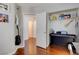 Bedroom featuring guitars, piano, closet with shelves and wood laminate flooring at 10645 Lace Vine Arbor Ave, Las Vegas, NV 89144