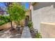 Inviting front entrance with a paved walkway, lush greenery, a well-manicured lawn, enhancing curb appeal at 10645 Lace Vine Arbor Ave, Las Vegas, NV 89144