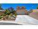 Charming two-story home featuring a well-maintained yard with mature landscaping, a concrete driveway, and an attached two-car garage at 10645 Lace Vine Arbor Ave, Las Vegas, NV 89144