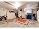 Garage interior with concrete floor, storage cabinets, overhead lighting and area rug at 10645 Lace Vine Arbor Ave, Las Vegas, NV 89144
