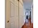Hallway featuring hardwood floors and ample closet space for storage at 10645 Lace Vine Arbor Ave, Las Vegas, NV 89144