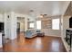 Open concept living area with wood floors, neutral walls, recessed lighting, seamless transition to dining and kitchen at 10645 Lace Vine Arbor Ave, Las Vegas, NV 89144