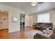 Cozy living room featuring hardwood floors, neutral walls, a comfortable seating arrangement, and a bright, airy atmosphere at 10645 Lace Vine Arbor Ave, Las Vegas, NV 89144