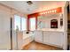 Bright bathroom features a double sink vanity, separate shower, and soaking tub with large window at 10645 Lace Vine Arbor Ave, Las Vegas, NV 89144