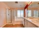 Bright bathroom features a double sink vanity, separate shower, and soaking tub with bright natural light at 10645 Lace Vine Arbor Ave, Las Vegas, NV 89144
