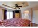 Spacious main bedroom featuring unique ceiling design, ensuite access and natural light at 10645 Lace Vine Arbor Ave, Las Vegas, NV 89144