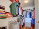 Spacious walk-in closet with built-in shelving and ample storage space with wood floors at 10645 Lace Vine Arbor Ave, Las Vegas, NV 89144
