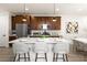 Stylish kitchen island with seating, stainless steel appliances, and dark wood cabinets at 11756 Emerald Lake Ave, Las Vegas, NV 89138
