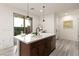 Stylish kitchen featuring an island with stainless steel appliances and modern pendant lighting at 11756 Emerald Lake Ave, Las Vegas, NV 89138