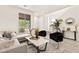 Bright living room with modern decor, comfortable seating, and a large window at 11756 Emerald Lake Ave, Las Vegas, NV 89138