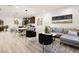 Open-concept living space with modern decor, stylish seating, and hardwood flooring at 11756 Emerald Lake Ave, Las Vegas, NV 89138