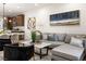 Comfortable living room with modern furnishings, a large sofa, and hardwood floors at 11756 Emerald Lake Ave, Las Vegas, NV 89138