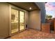 Brick-paved patio with sliding glass doors leads to a modern kitchen and dining area at 11756 Emerald Lake Ave, Las Vegas, NV 89138