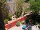 Beautiful backyard showcasing a colorful garden, brick-paved patio, and mature trees for privacy at 11832 Arenoso Dr, Las Vegas, NV 89138