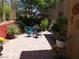 Fully landscaped backyard with a patio table and plenty of greenery at 11832 Arenoso Dr, Las Vegas, NV 89138