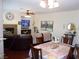 Open concept dining room and living room, with a fireplace, large flat screen TV, and plenty of seating at 11832 Arenoso Dr, Las Vegas, NV 89138