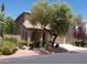 Exterior elevation of two-story home featuring desert landscaping and arched entry at 11832 Arenoso Dr, Las Vegas, NV 89138