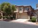 Two-story home with a two-car garage, desert landscaping, and a tile roof at 11832 Arenoso Dr, Las Vegas, NV 89138
