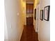 Well-lit hallway with rich wood floors and elegant decor at 11832 Arenoso Dr, Las Vegas, NV 89138