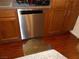 Stainless steel dishwasher is set amongst dark wood cabinets and countertops at 11832 Arenoso Dr, Las Vegas, NV 89138