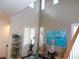 Bright living room with high ceilings, tall shuttered windows, and hardwood floors at 11832 Arenoso Dr, Las Vegas, NV 89138
