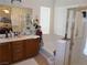 Bright bathroom featuring double sinks, a soaking tub, and a glass-enclosed shower at 11832 Arenoso Dr, Las Vegas, NV 89138