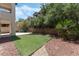 Private backyard featuring low maintenance artificial turf and mature landscaping, great for relaxing and entertaining at 11900 Calle De Sol Dr, Las Vegas, NV 89138