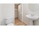 Bathroom features a pedestal sink, toilet and closet at 11900 Calle De Sol Dr, Las Vegas, NV 89138