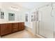 Bathroom with double vanity, large mirror, soaking tub, and glass enclosed shower at 11900 Calle De Sol Dr, Las Vegas, NV 89138