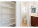 Powder room with open shelving, toilet, and sink at 11900 Calle De Sol Dr, Las Vegas, NV 89138