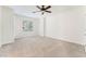 Well-lit bedroom with a ceiling fan and a large window, carpeted floors at 11900 Calle De Sol Dr, Las Vegas, NV 89138