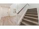 Welcoming entryway with wood-look floors leading to a staircase and featuring a front door and windows for light at 11900 Calle De Sol Dr, Las Vegas, NV 89138