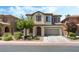 Charming two-story home with a well-maintained front yard, two-car garage, and traditional Southwest architecture at 11900 Calle De Sol Dr, Las Vegas, NV 89138