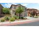 Inviting two-story home with a tile roof, neutral paint, an attached garage, and tasteful desert landscaping at 11900 Calle De Sol Dr, Las Vegas, NV 89138
