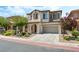 Charming two-story home featuring a well-manicured lawn, attached two-car garage, and tasteful desert landscaping at 11900 Calle De Sol Dr, Las Vegas, NV 89138
