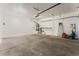 The spacious garage features an updated garage door, ample space, and neutral paint at 11900 Calle De Sol Dr, Las Vegas, NV 89138
