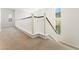 Hallway with white railings and multiple windows at 11900 Calle De Sol Dr, Las Vegas, NV 89138
