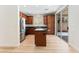 Well-lit kitchen features wood cabinets, an island, stainless steel appliances and sliding glass doors at 11900 Calle De Sol Dr, Las Vegas, NV 89138