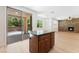Kitchen island next to sliding glass doors and view of the living room at 11900 Calle De Sol Dr, Las Vegas, NV 89138