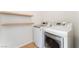 Laundry room featuring modern, front-loading washer and dryer plus built-in shelving at 11900 Calle De Sol Dr, Las Vegas, NV 89138