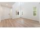 Bright, airy living room featuring high ceilings, wood-look floors, and multiple windows for abundant natural light at 11900 Calle De Sol Dr, Las Vegas, NV 89138