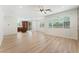 Expansive living room with wood-look floors, seamlessly connecting to kitchen, providing ample natural light through large windows at 11900 Calle De Sol Dr, Las Vegas, NV 89138