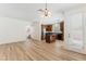 Open-concept living space with wood-look floors, seamlessly connecting to a modern kitchen with dark wood cabinets at 11900 Calle De Sol Dr, Las Vegas, NV 89138