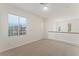 A loft area with carpet flooring and multiple windows at 11900 Calle De Sol Dr, Las Vegas, NV 89138