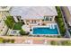 Aerial view of a modern home highlighting its backyard pool, fire pit area, and outdoor living space at 12382 Tudor Arch Dr, Las Vegas, NV 89138