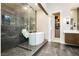 This luxurious bathroom showcases a glass walk-in shower with a soaking tub at 12382 Tudor Arch Dr, Las Vegas, NV 89138