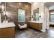 Spa-like bathroom with dual vanities, modern fixtures, and stylish tiled walls at 12382 Tudor Arch Dr, Las Vegas, NV 89138