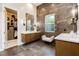 Modern bathroom with dual vanities, walk-in closet, and sleek tiling at 12382 Tudor Arch Dr, Las Vegas, NV 89138