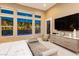 Bedroom with large windows, backyard views, and contemporary furnishings at 12382 Tudor Arch Dr, Las Vegas, NV 89138