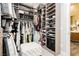 Spacious walk-in closet with ample storage and decorative ottoman seating at 12382 Tudor Arch Dr, Las Vegas, NV 89138